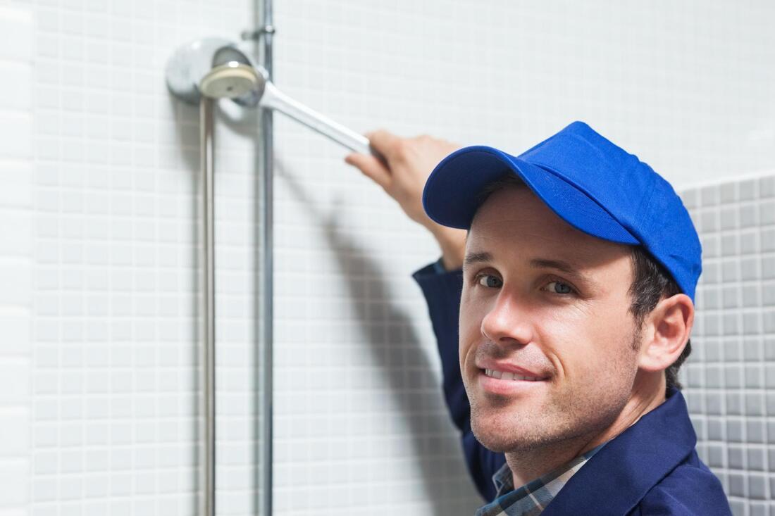 man fixing the bathroom shower